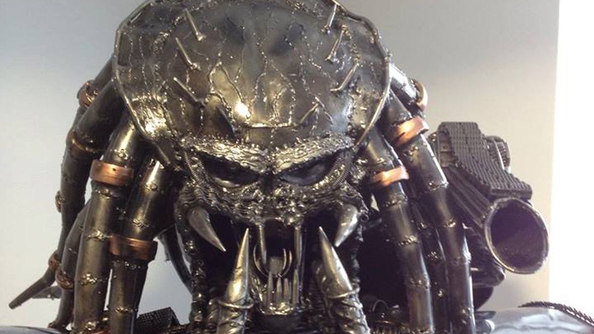 The head of a metal Predator statue that our team moved